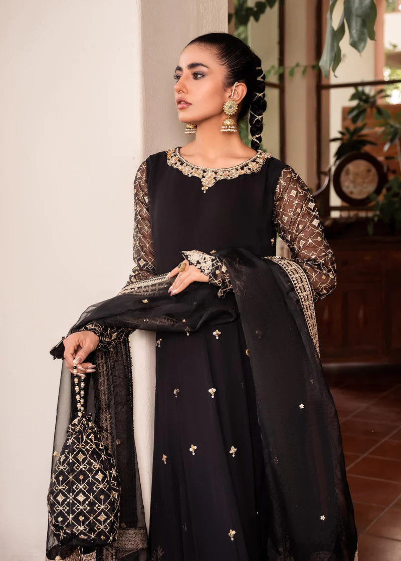 a woman in a black dress standing in a room