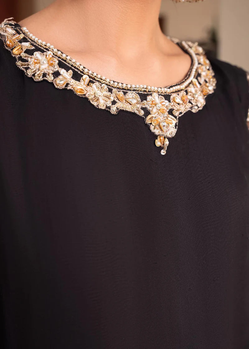 a close up of a woman wearing a necklace and earrings