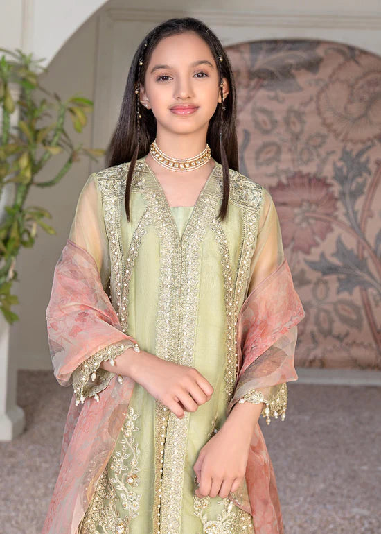 a Pakistani young girl wearing a green and pink outfit
