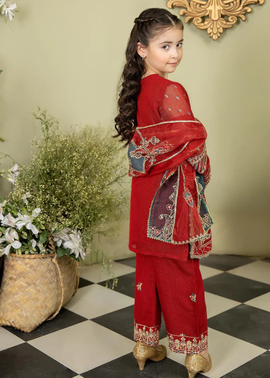 a little girl in a red outfit standing on a checkered floor