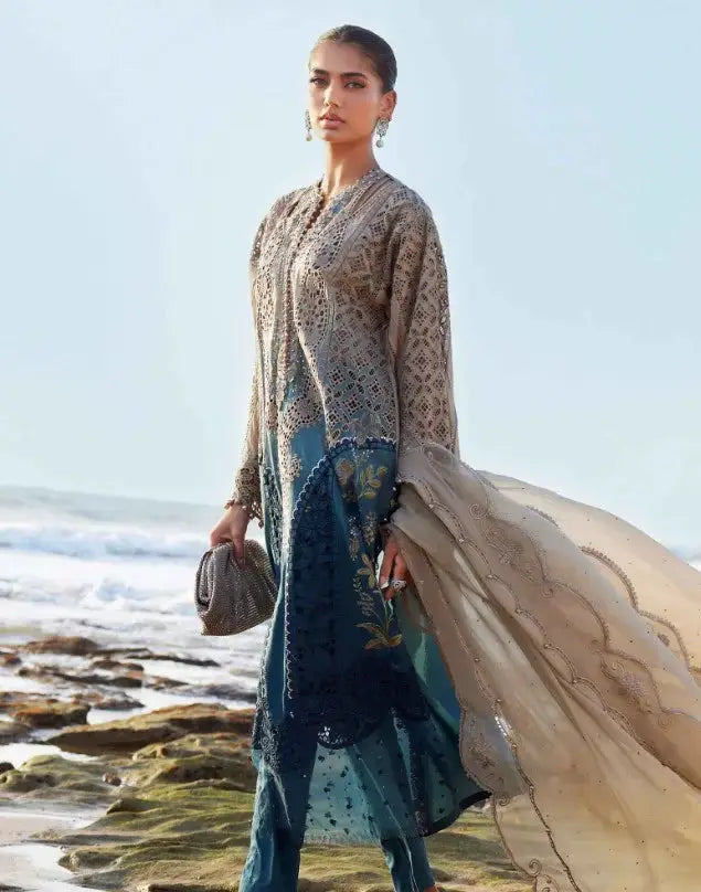 Elegant 3 PIECE LUXURY LAWN AL-4303 suit with intricate embroidery and 3D floral accents, styled for formal wear by the seaside.
