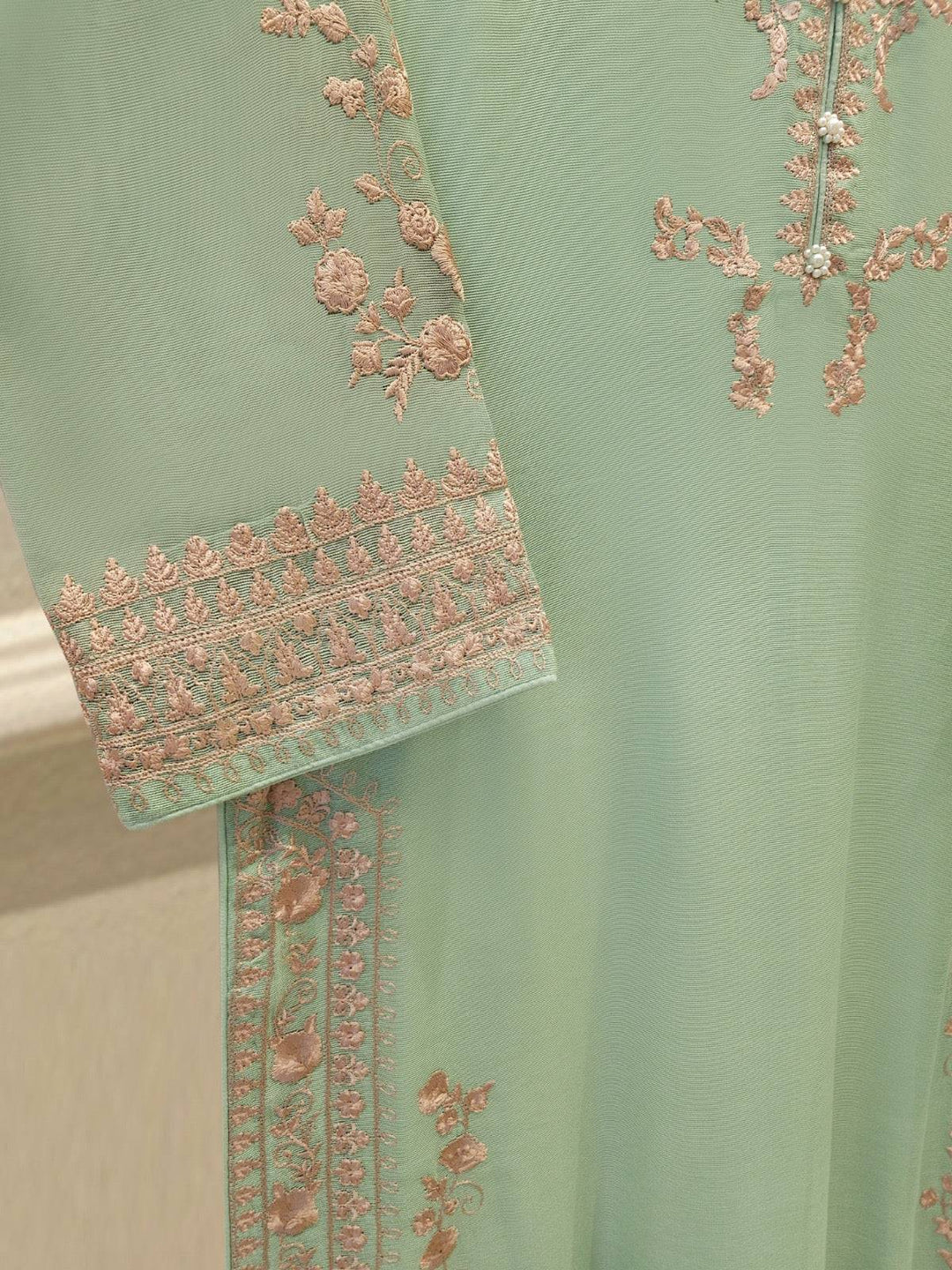 Sleeve embroidery of AGHA NOOR 2 Piece Suit with intricate pink floral patterns on cotton net, adding elegance to the design.