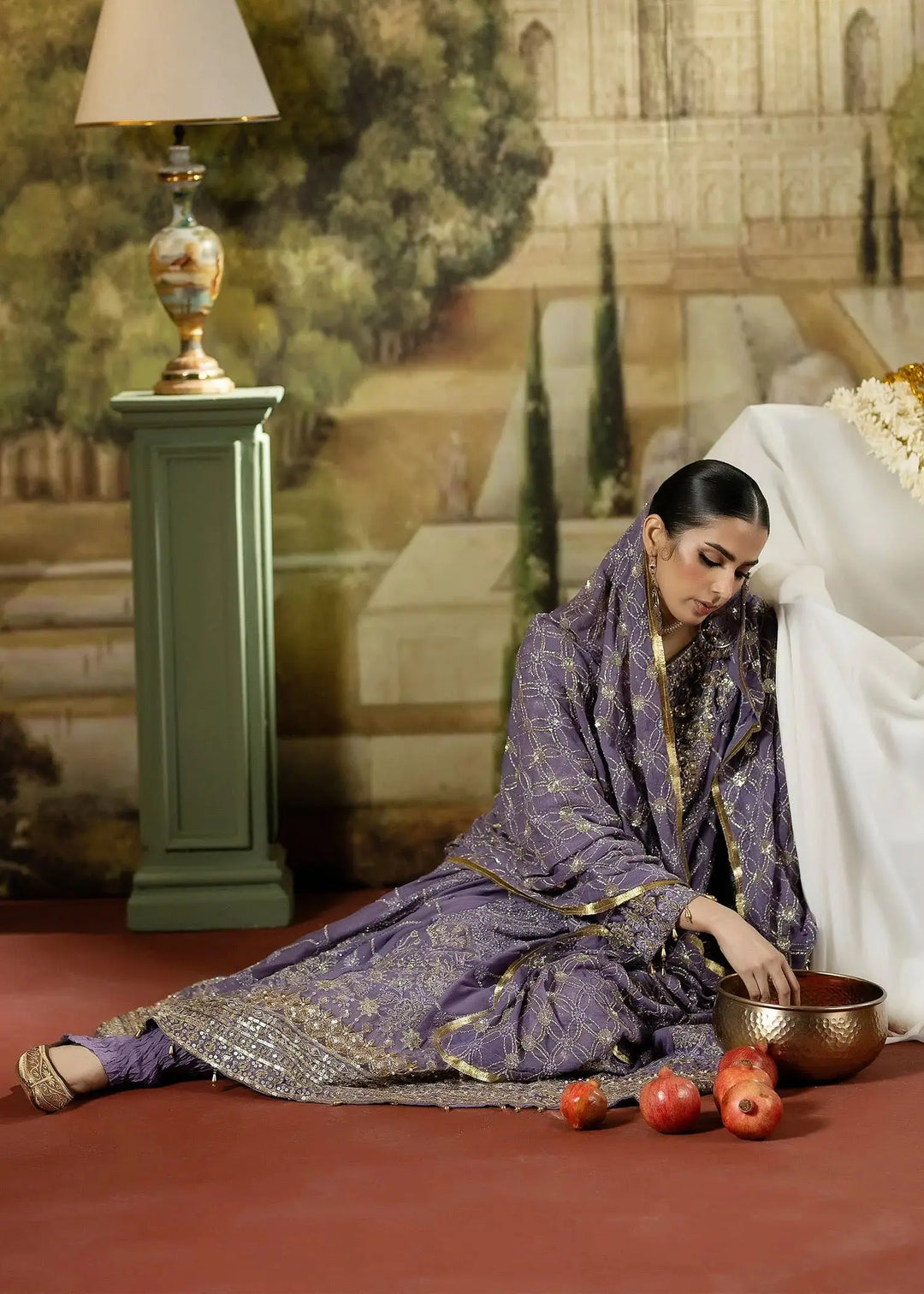 Model seated in RANGREZA PURPLE embroidered chiffon Pakistani party dress with gold accents, styled with matching dupatta and crinkled trousers.