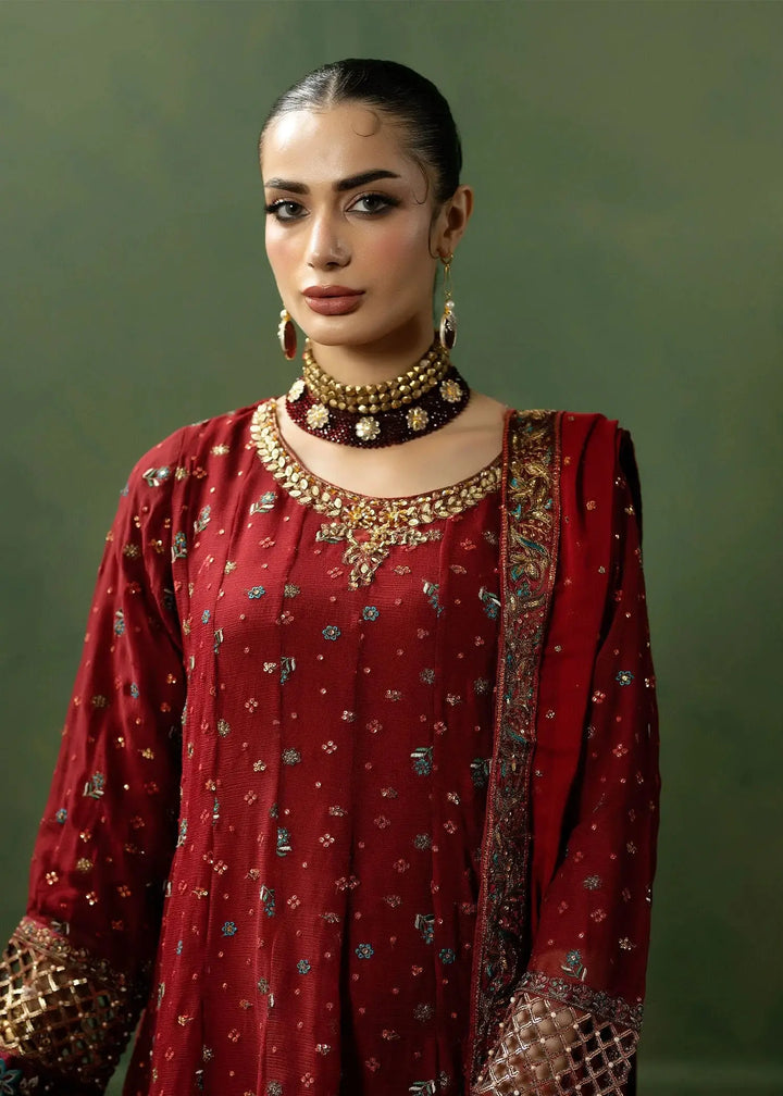 Close-up of RANGREZA RED red colour dresses pakistani showing detailed neckline embroidery and rich fabric texture of the frock and dupatta.