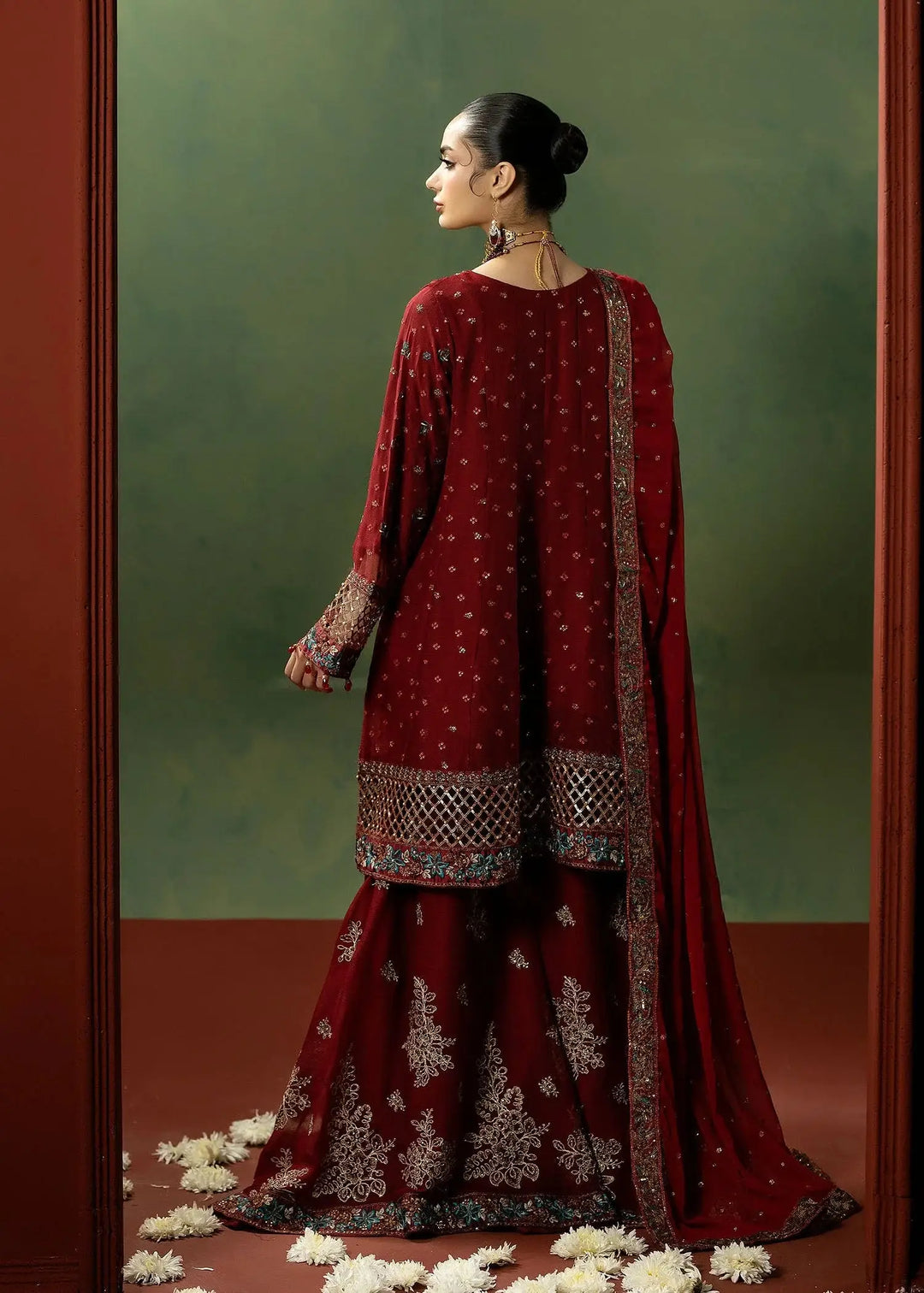 Back view of RANGREZA RED red colour dresses pakistani with intricate embroidery on chiffon dupatta and sharara, ideal for festive occasions.