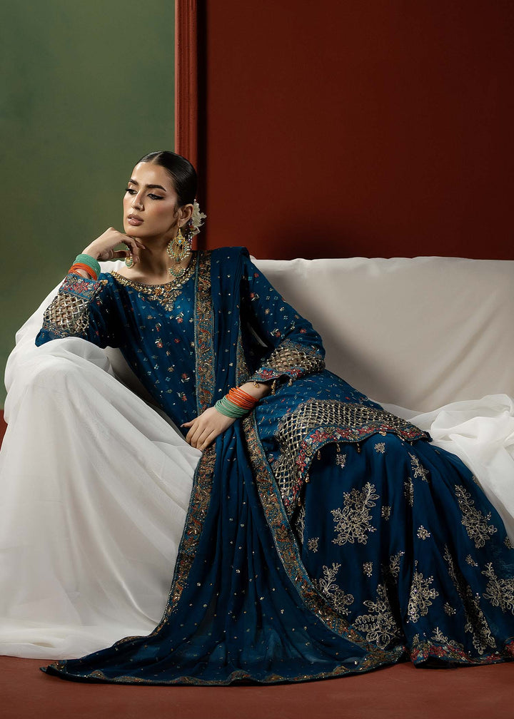 Pakistani brand RANGREZA BLUE | M-909-16 embroidered peplum frock with detailed dupatta and bottom, styled for formal ethnic occasions.