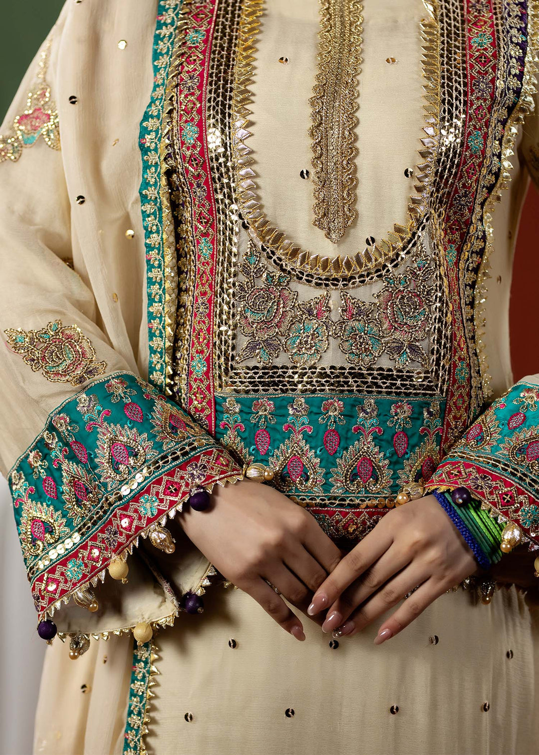 Detailed embroidery on RANGREZA OFF White shirt front and sleeves with gold, pink, and teal threadwork, perfect for a Pakistani wedding look.
