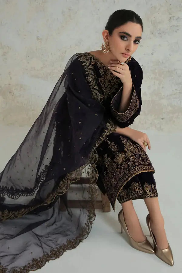 Seated model in Embroidered Velvet SF-239, displaying the ornate embroidery on the shirt and pants with a flowing organza dupatta.