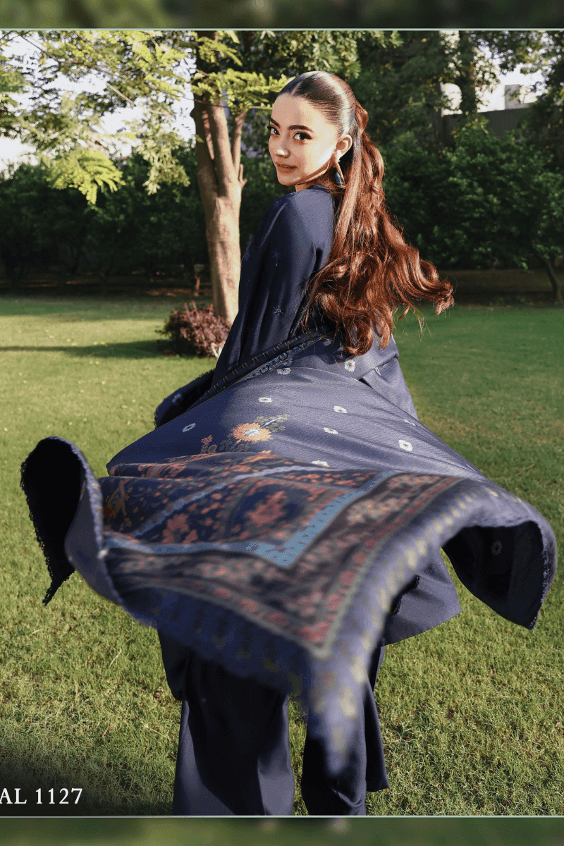Model twirling in RANGREZA AL-1127 embroidered outfit with flowing wool shawl, highlighting premium Pakistani winter clothing.