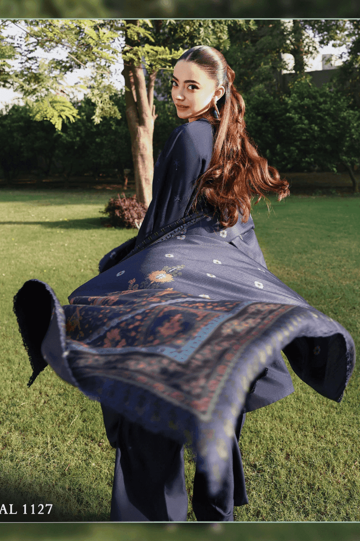 Model twirling in RANGREZA AL-1127 embroidered outfit with flowing wool shawl, highlighting premium Pakistani winter clothing.