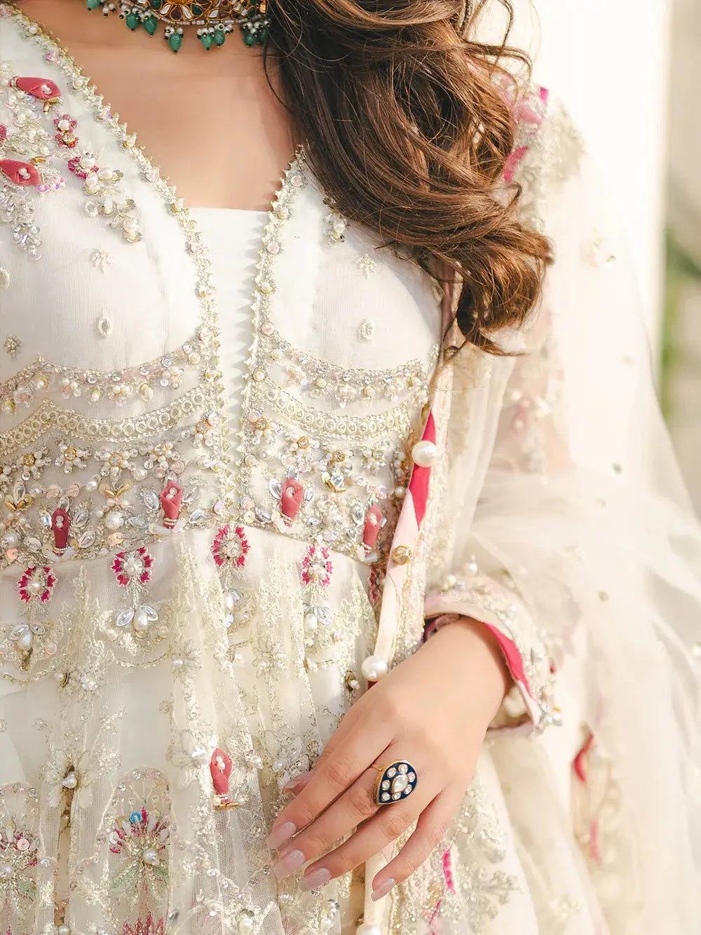 Embroidered net fabric peplum with sequin, adda, naqshi, dabka, pearls, crystals, chainwork, lace, and paranda tassels, paired with a detailed net dupatta with spangle embroidery, pearls, gotta patti, and beads, part of the AROOSH RUHI collection