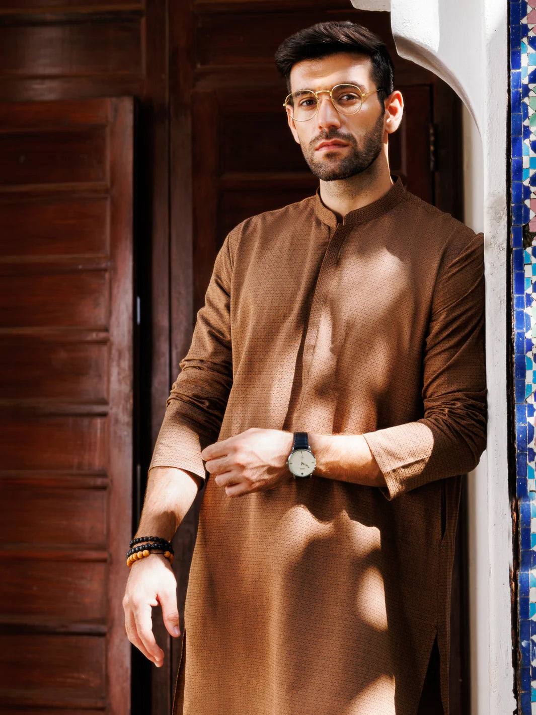 Close-up of brown kurta fabric with subtle dotted pattern, front view of the shirt