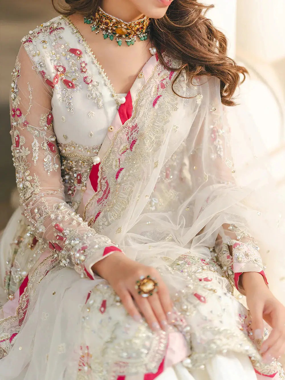 Embroidered net fabric peplum with sequin, adda, naqshi, dabka, pearls, crystals, chainwork, lace, and tassels for wedding attire