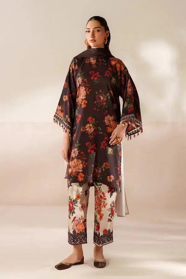 Model wearing floral printed black kurta with embroidered border and white floral trousers