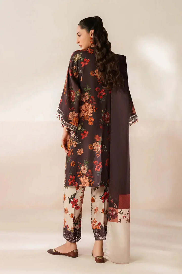 Side view of model in floral black kurta with matching embroidered dupatta and floral trousers