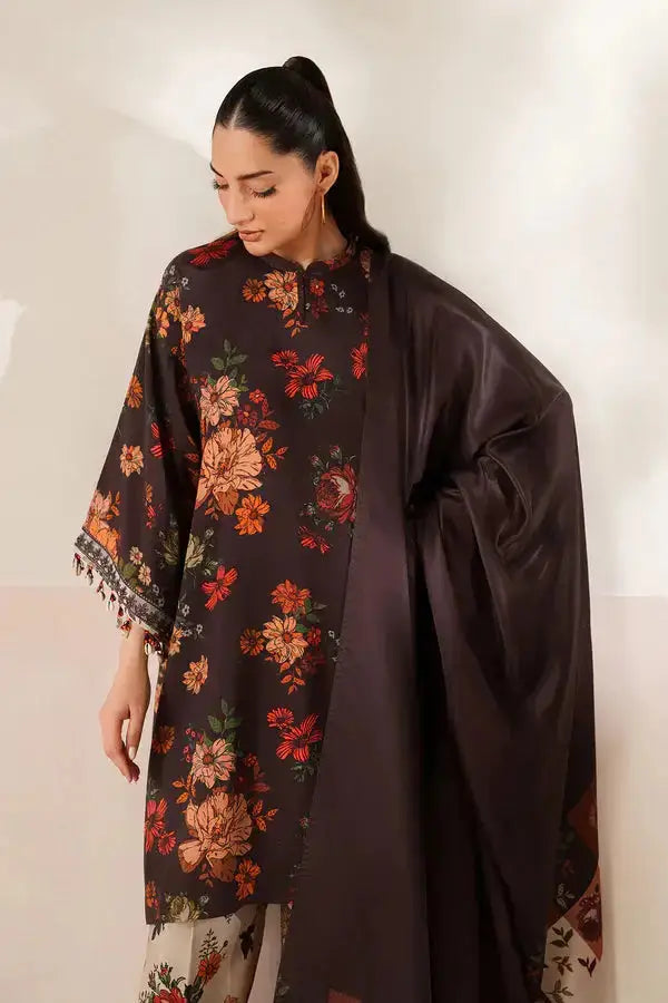 Close-up of embroidered border on black floral kurta sleeve with tassel details