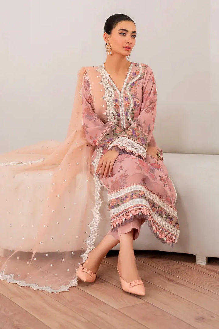 Model sitting in EMBROIDERED CHIFFON-SF-705 pink chiffon suit with embroidered neckline, lace accents, and elegant dupatta.