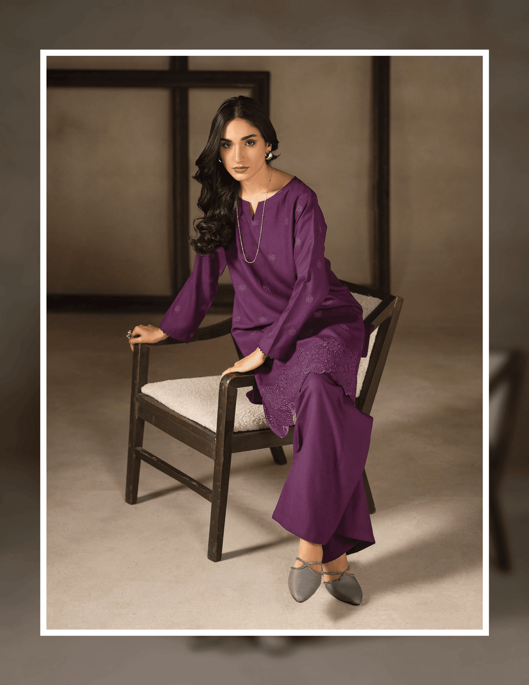 Model seated in RANGREZA EA-45-38 purple kurta and trouser set, showcasing elegant embroidery and winter-ready Dhanak fabric.