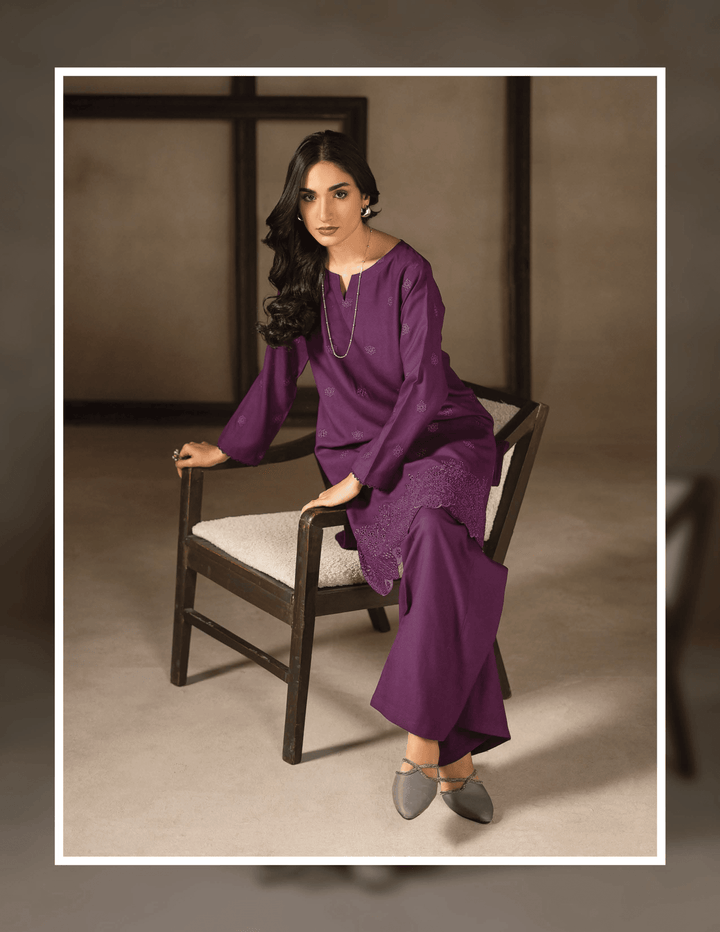 Model seated in RANGREZA EA-45-38 purple kurta and trouser set, showcasing elegant embroidery and winter-ready Dhanak fabric.