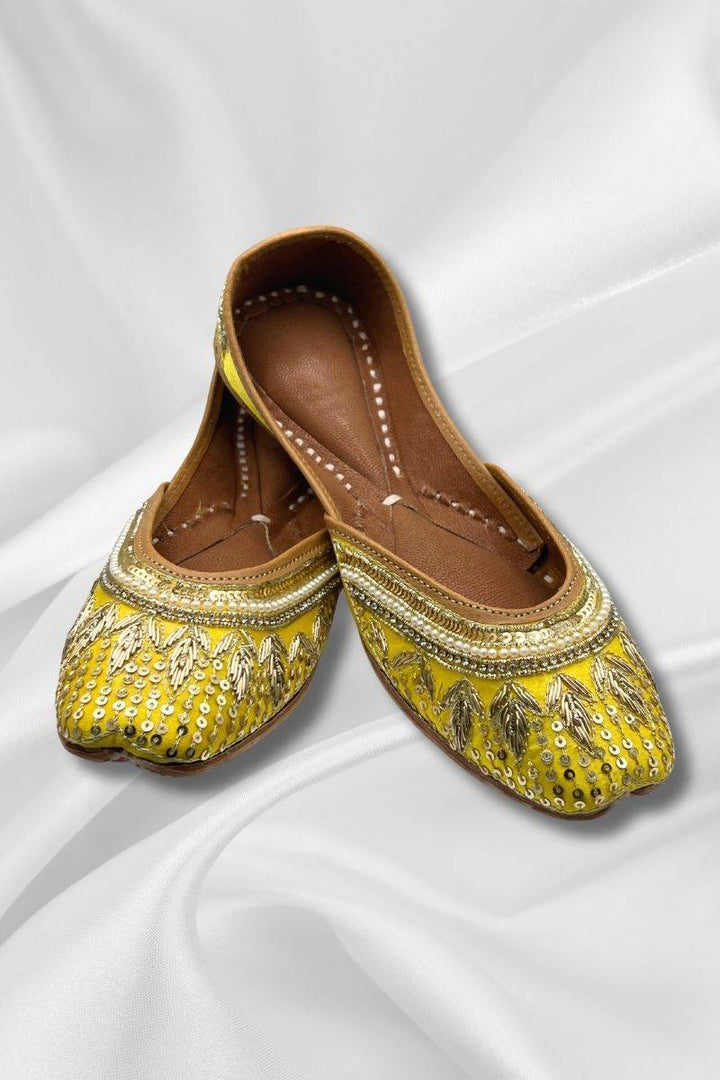 Zeenat Yellow Jutti - Pakistani Khussa with gold sequins and pearl trim, featuring intricate embroidery on bright yellow fabric for festive wear.