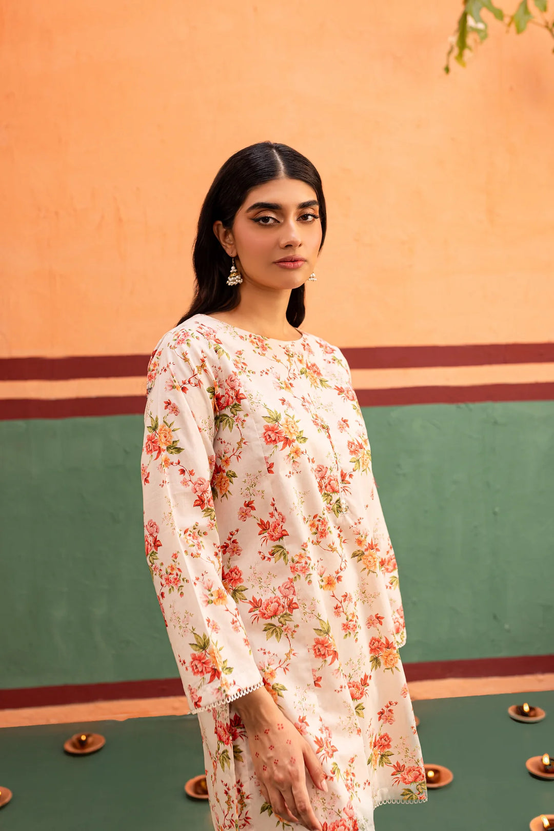 a BATIK READY TO WEAR woman standing in front of a wall