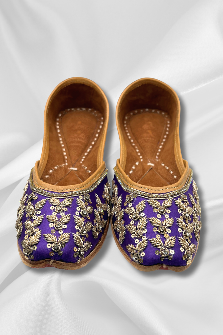 Elegant Amber Purple Jutti with intricate gold embroidery and silver stones, perfect women's Khusa for traditional outfits and special occasions.
