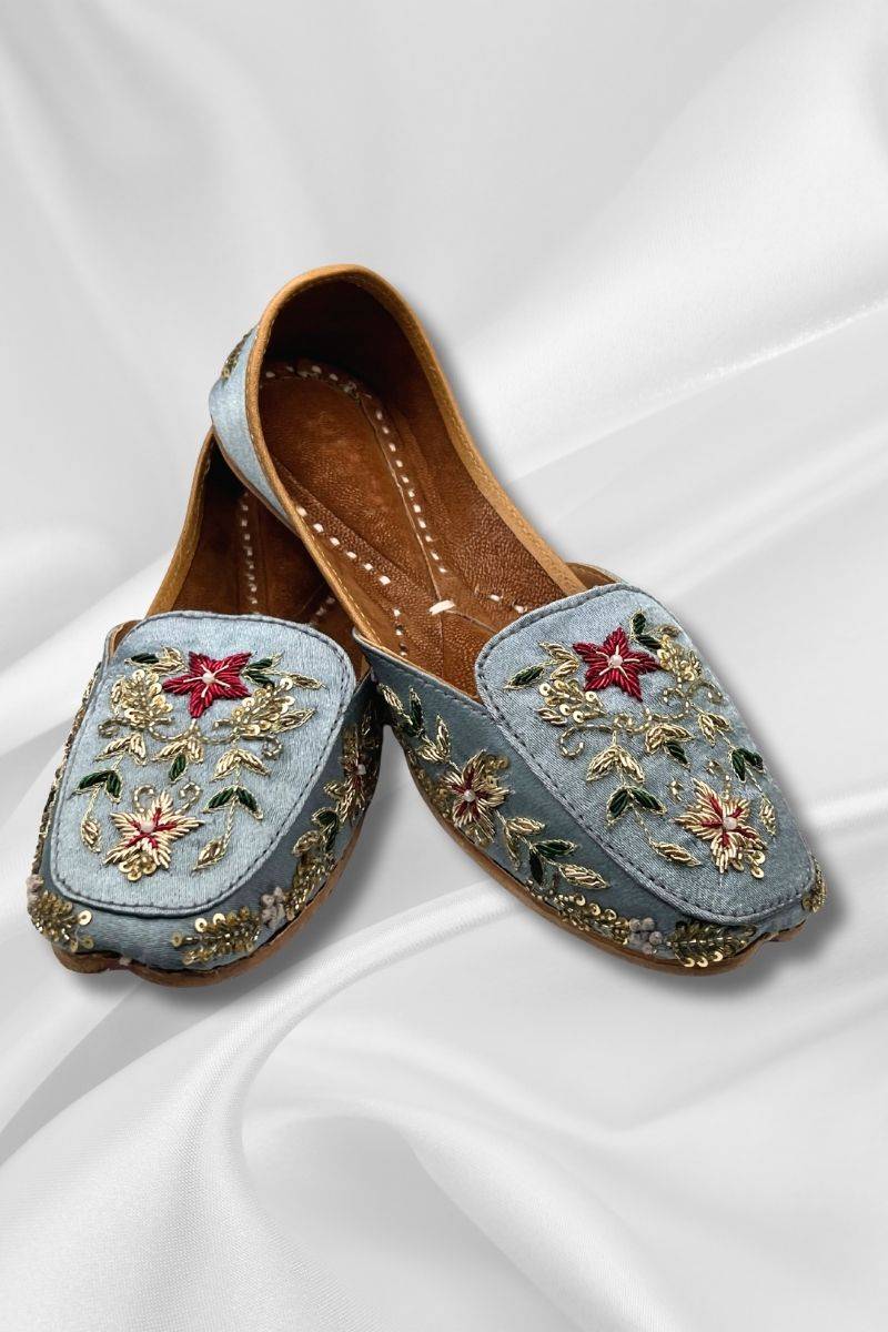 Bahaar IceBlue Jutti - Handcrafted Pakistani khussa flats featuring intricate gold threadwork and red floral accents on soft blue fabric.