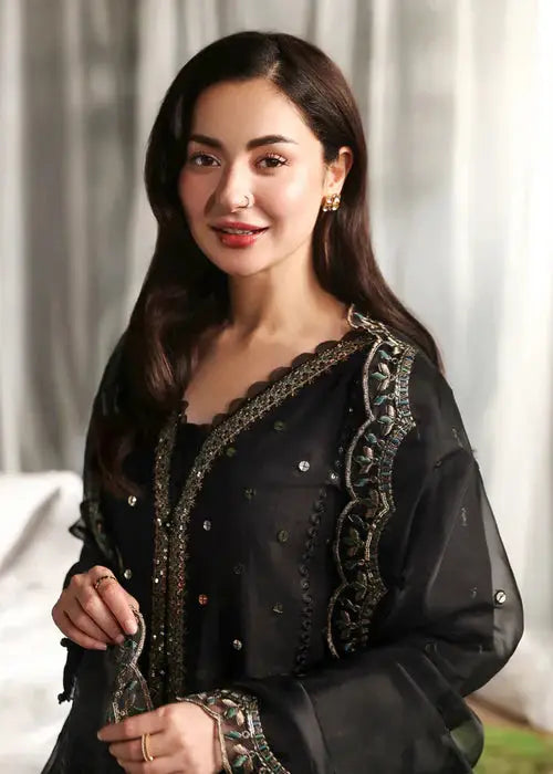 Elegant woman in black embroidered traditional dress