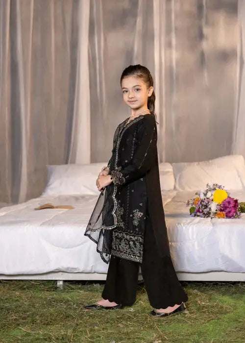 Side view of girl in black embroidered dress with dupatta