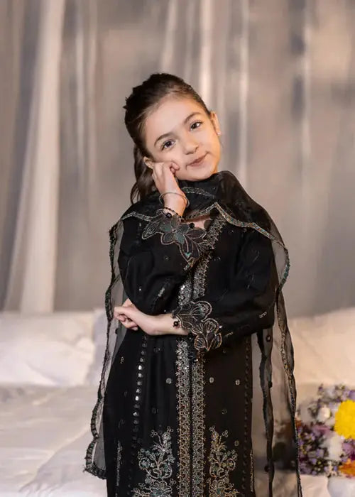 Girl in black embroidered dress with dupatta, posing