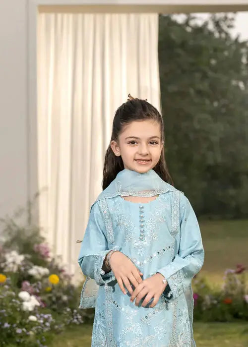 Young girl in light blue traditional dress outdoors
