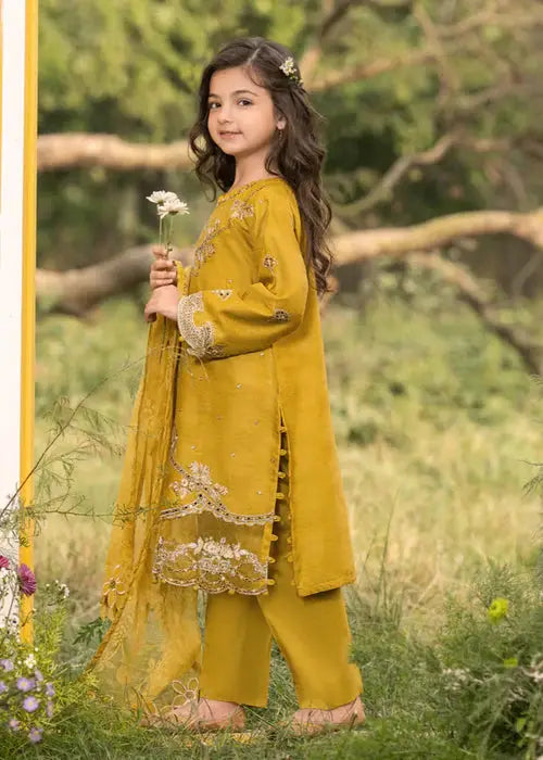 Girl in yellow traditional dress with flower in hand outdoors
