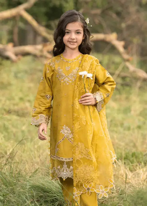 Young girl in yellow traditional dress holding white flowers outdoors