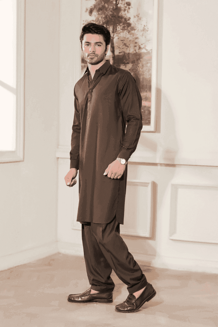 Model wearing Brown MA-105 kameez shalwar set, styled for men with classic tailoring and comfortable wash n wear material.