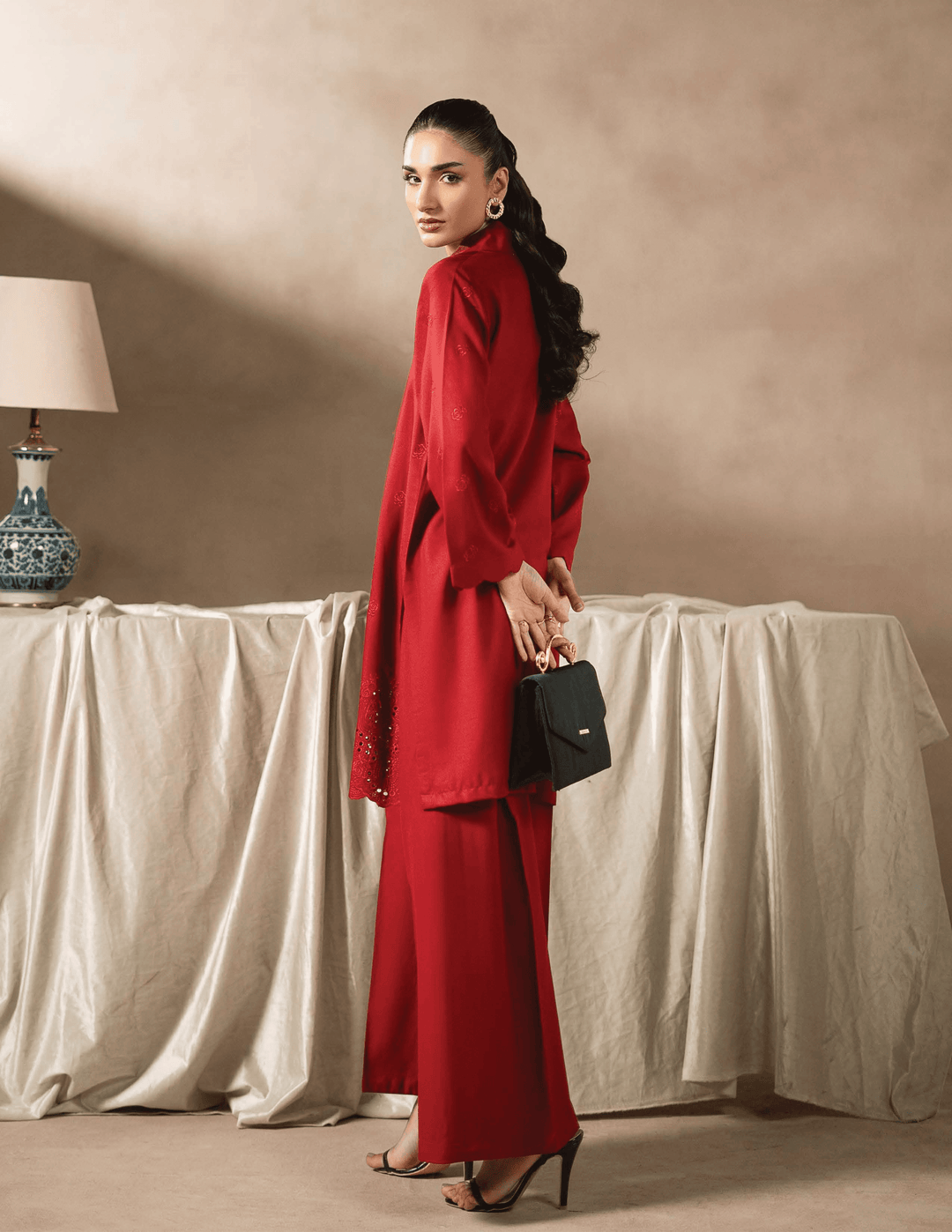 Side pose of RANGREZA EA-48-3803 red kurta set with elegant fall and minimal accessories. Discover Pakistani two piece dresses for women.