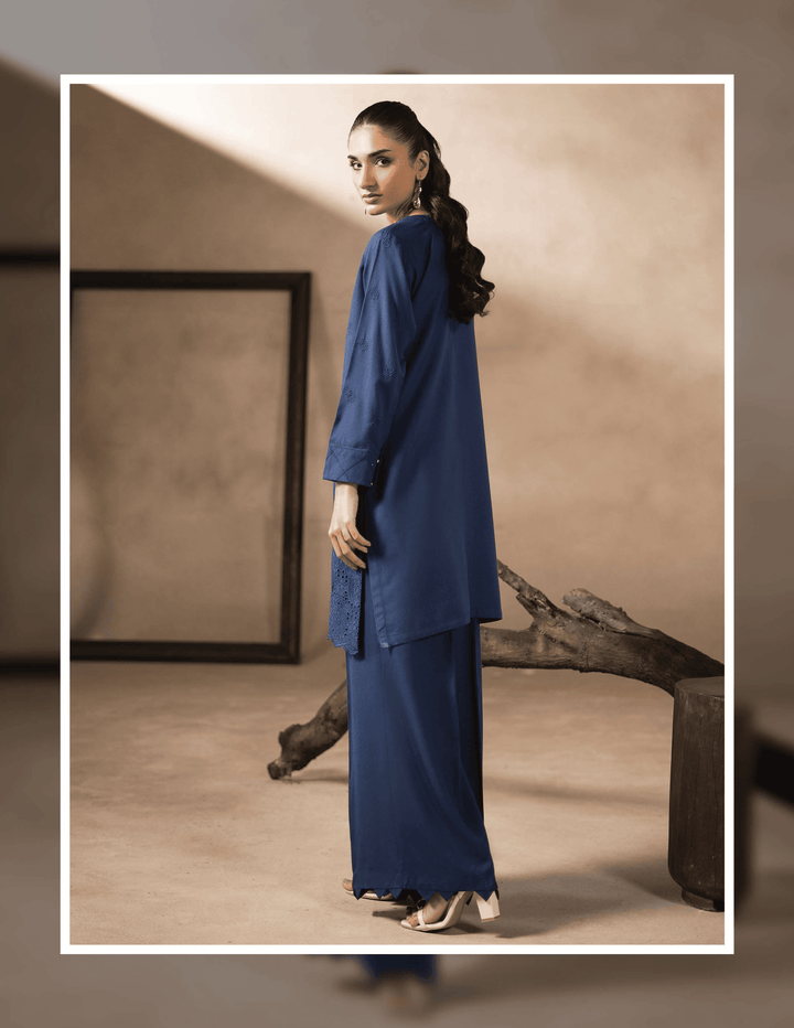 Back view of RANGREZA EA-42-38 stitched Pakistani two piece suit in deep blue Dhanak fabric, showcasing relaxed fit and elegant winter design.