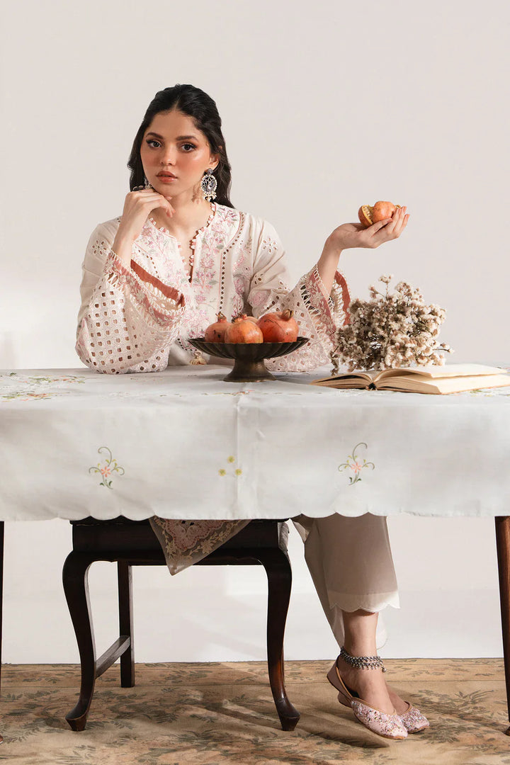 Model wearing ETHNC EMBROIDERED SUIT - Ethnic USA seated at table, highlighting embroidered tunic and traditional elegance in apparel styling.