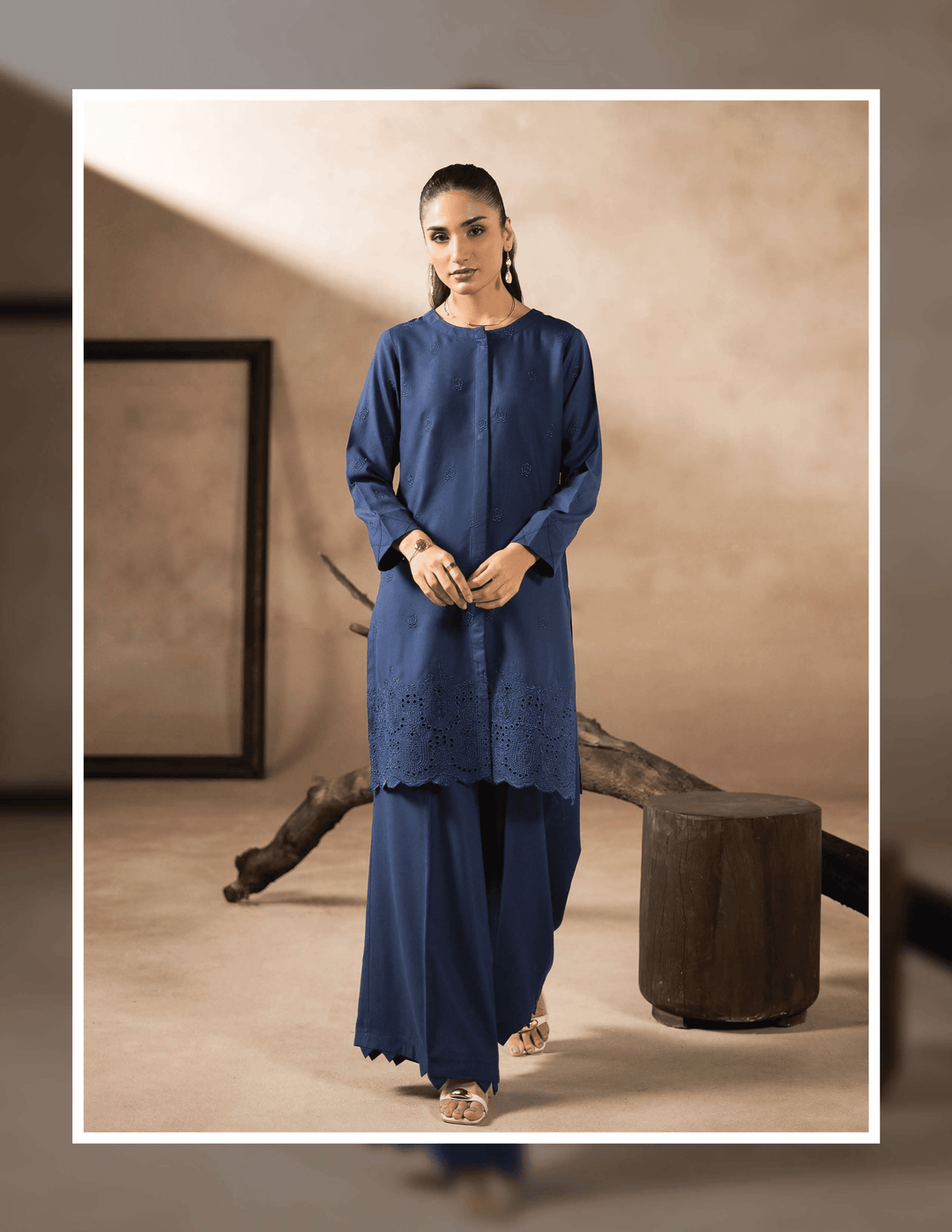 Model wearing RANGREZA EA-42-38 stitched Pakistani two piece suit with laser-cut hem kurta and matching trousers, perfect for winter casual outfits.