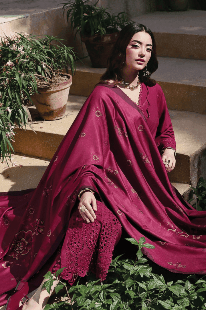 Model seated in RANGREZA AL-1131 outfit showcasing intricate chikankari embroidery and floral wool shawl in elegant maroon tone.