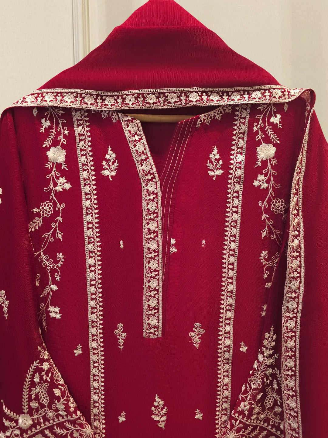 Close-up of AGHA NOOR Cotton Suit neckline with detailed white floral embroidery and fine stitching on the front panel of the shirt.
