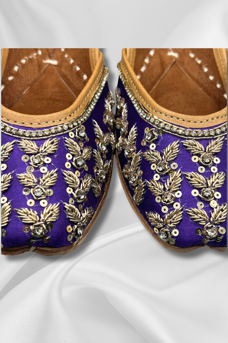 Close-up of Amber Purple Punjabi Jutti showcasing detailed gold leaf embroidery and silver sequins on satin, premium women's Khusa footwear.