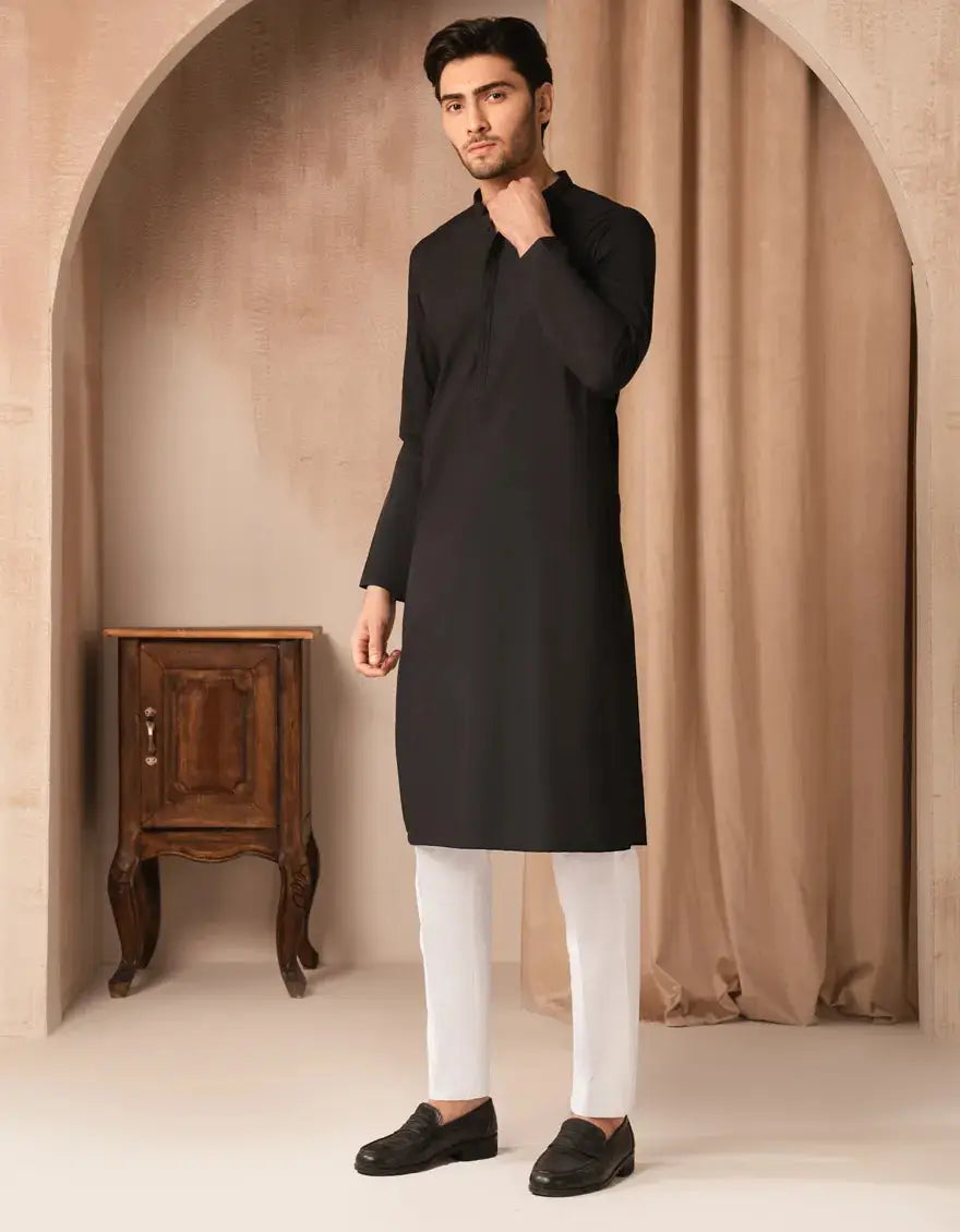 Black blended kurta for men in semi-formal regular fit, styled with white pants and black loafers. Ideal for festive and formal occasions.
