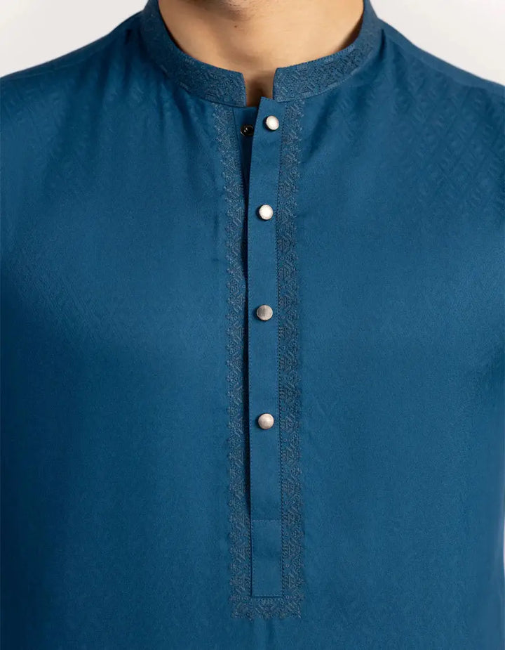 Detailed view of Blue Semi-Formal Kurta by Junaid Jamshed J., highlighting textured fabric, button placket, and embroidered neckline design.