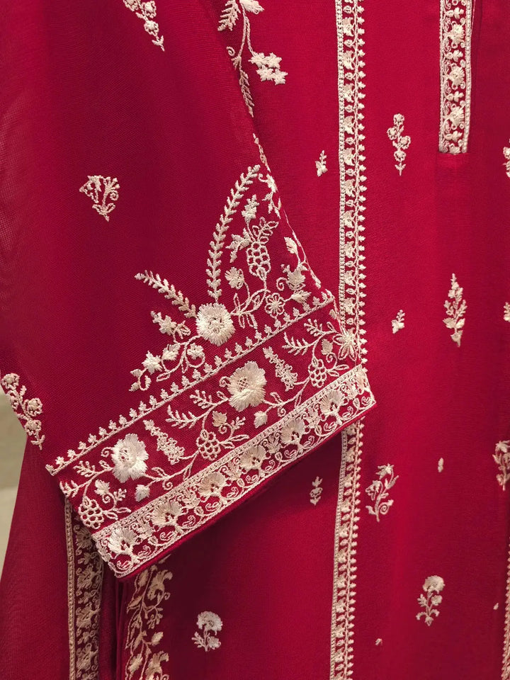 Detailed view of AGHA NOOR embroidered sleeve design with intricate white floral patterns on deep pink cotton net fabric.