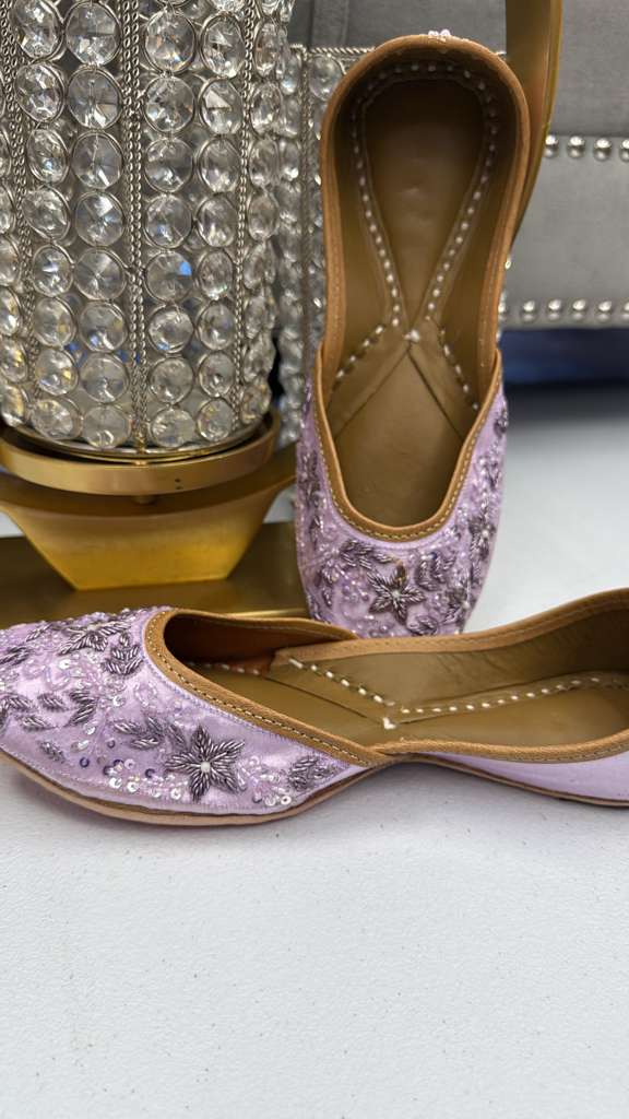 Lavender Chamak Jutti for women featuring hand-embroidered floral patterns and sequins, perfect for festive and elegant occasions.