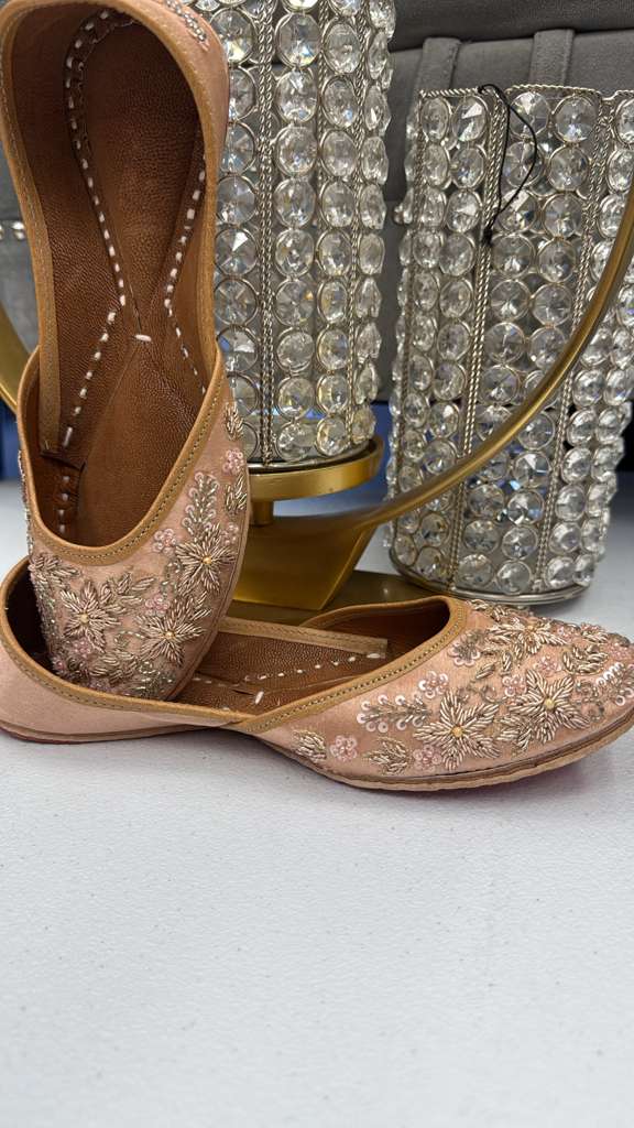 Elegant Azal Peach Jutti for women featuring intricate thread and sequin work, ideal for pairing with pastel outfits.