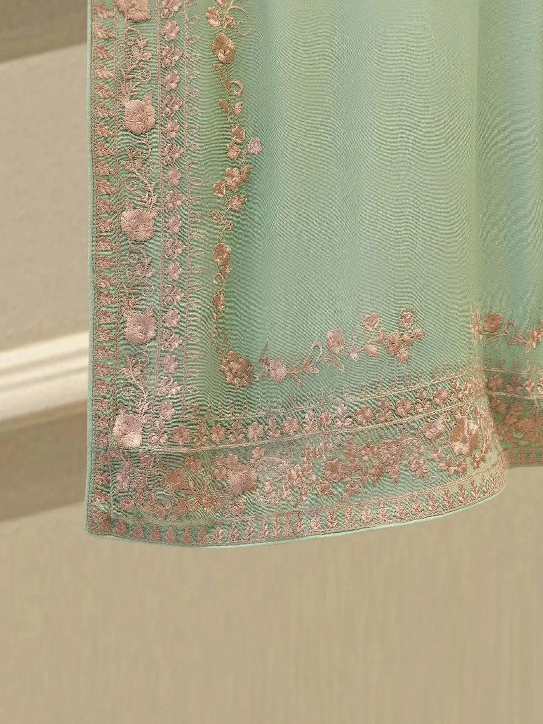 Detailed hem embroidery of AGHA NOOR Cotton Suit featuring floral pink threadwork on mint green fabric, enhancing the traditional appeal.