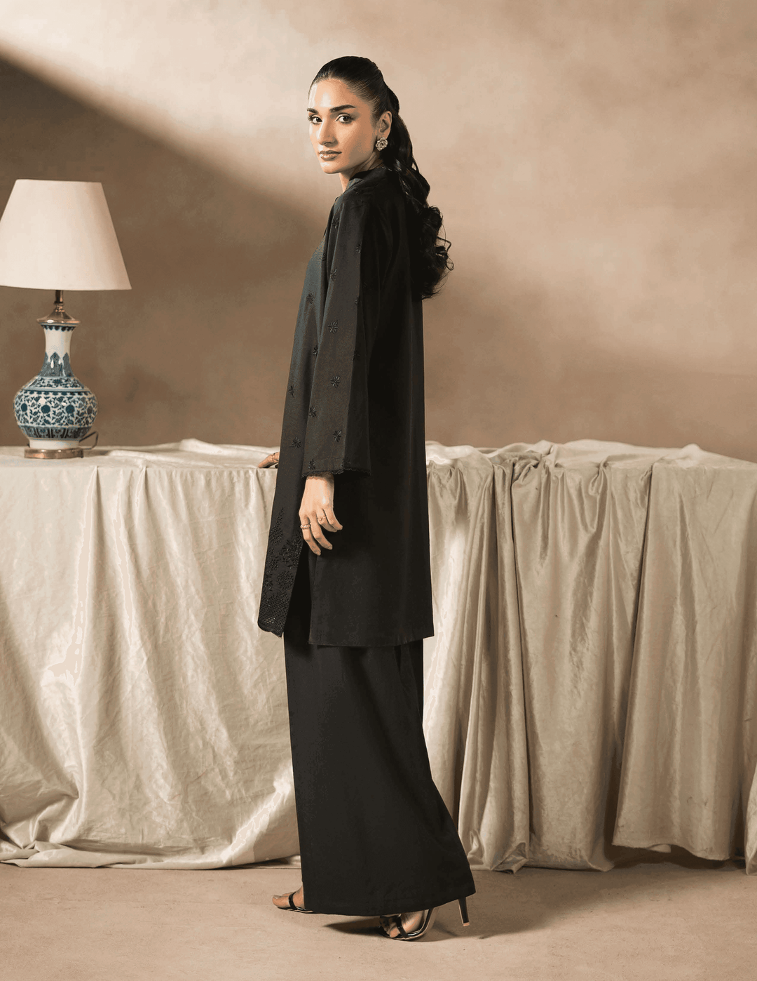 Back view of RANGREZA EA-43-38 Pakistani two piece suit featuring elegant embroidery and relaxed fit for contemporary winter fashion.