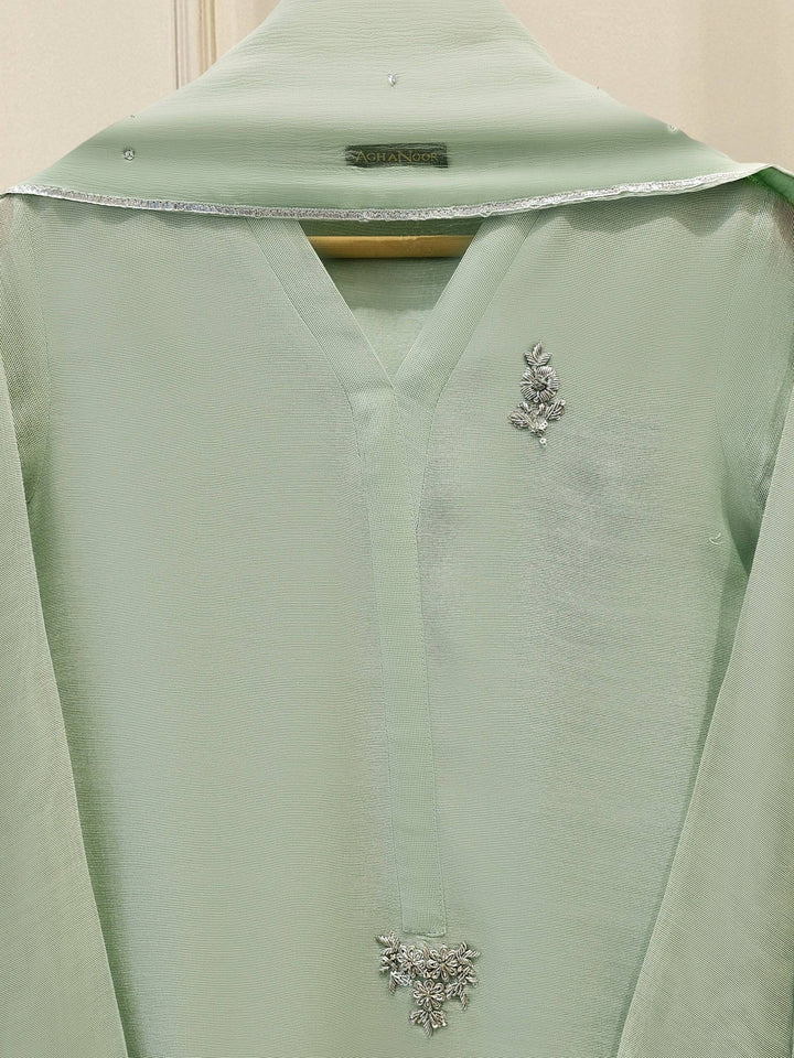 Close-up of Agha Noor embroidered neckline and chest detailing on mint green cotton net shirt for refined elegance.