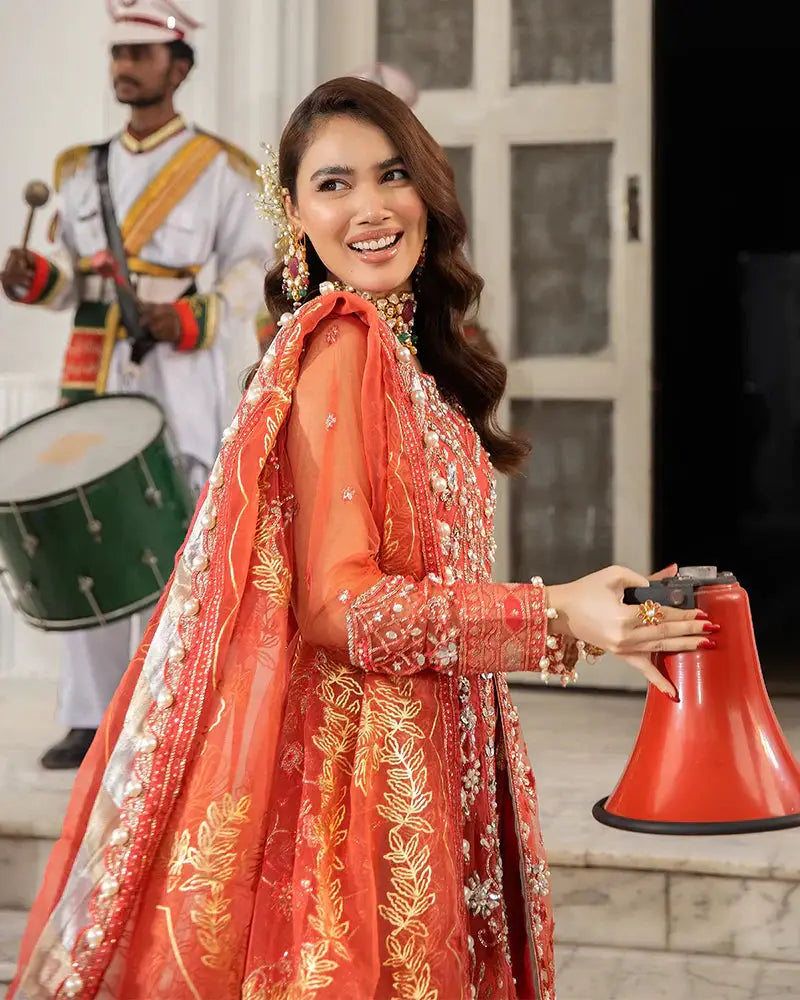 AROOSH AR-103-2200 wedding outfit highlights detailed embellishments on the red shirt and dupatta, ideal for traditional Pakistani celebrations. Features naqshi and dabka work.